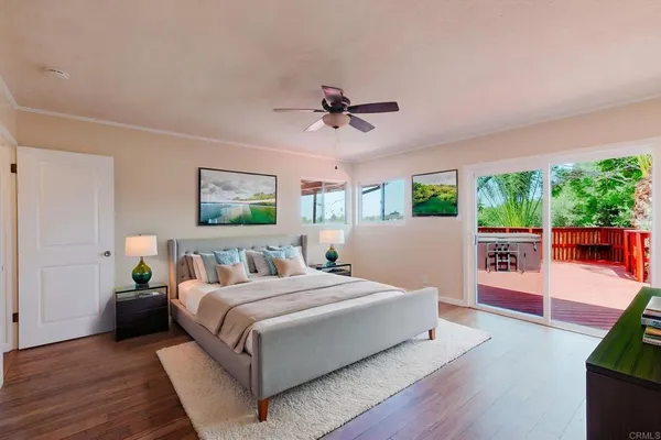 a bedroom with a large bed and a chandelier