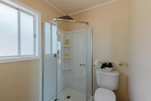 a bathroom with a toilet and shower
