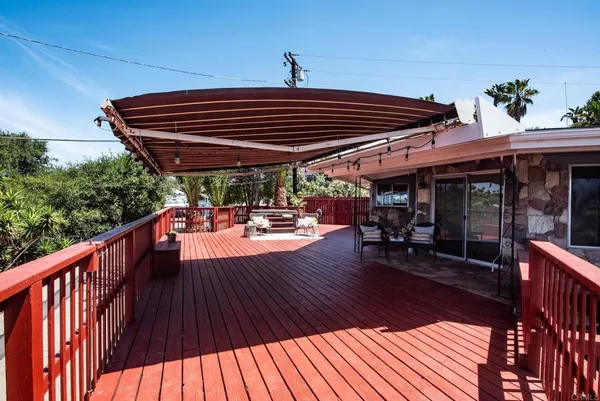 a view of sitting area with furniture and wooden deck