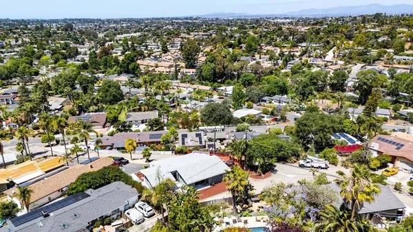 an aerial view of residential houses with city view