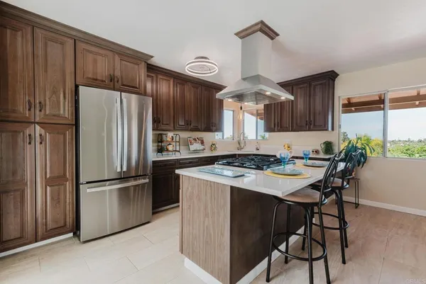 a kitchen with stainless steel appliances a stove a refrigerator and a refrigerator