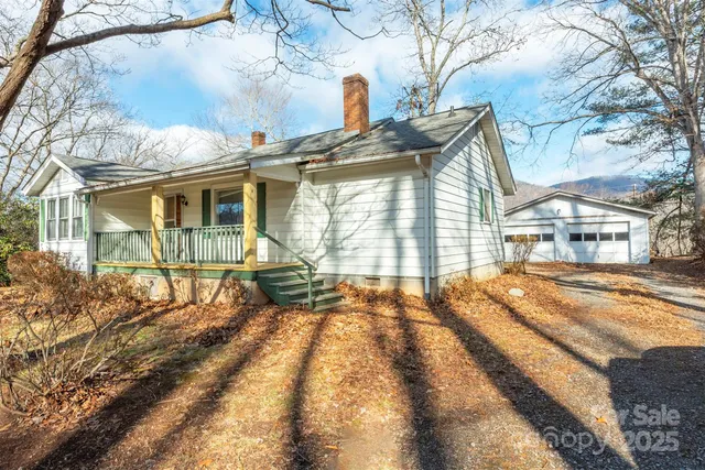 a view of a house with a large tree