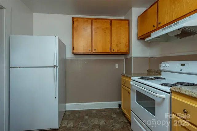 a kitchen with a stove and a refrigerator
