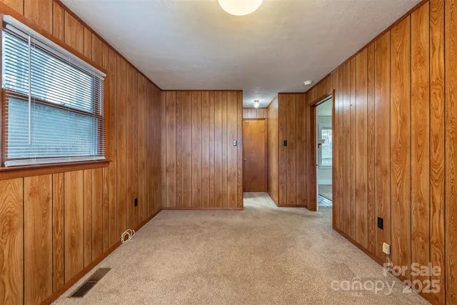 a view of an empty room with wooden walls