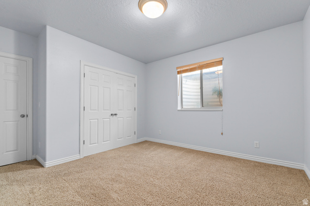 1501 West Elk Circle Mapleton, UT 84664 - Photo 34 of 39 Carpeted room featuring a double-door closet, a single window with blinds, and white trim
