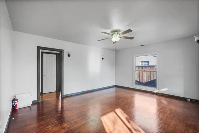 wooden floor in an empty room with a window