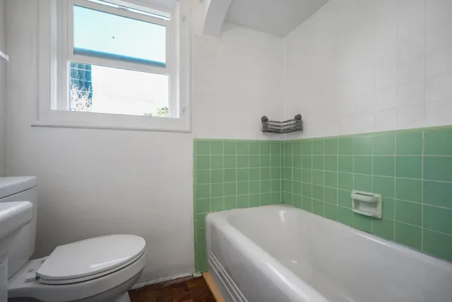 a bathroom with a toilet and bathtub