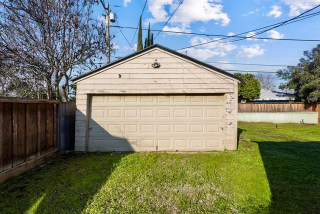 a view of a backyard with wooden fence