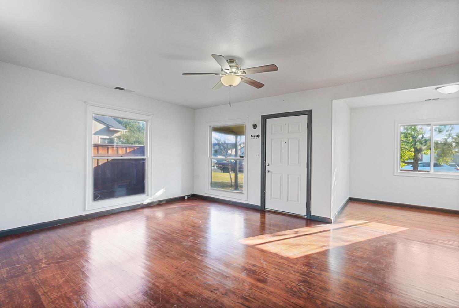 1899 Union Avenue Merced, CA 95340 - Photo 4 of 27 wooden floor in an empty room with a window