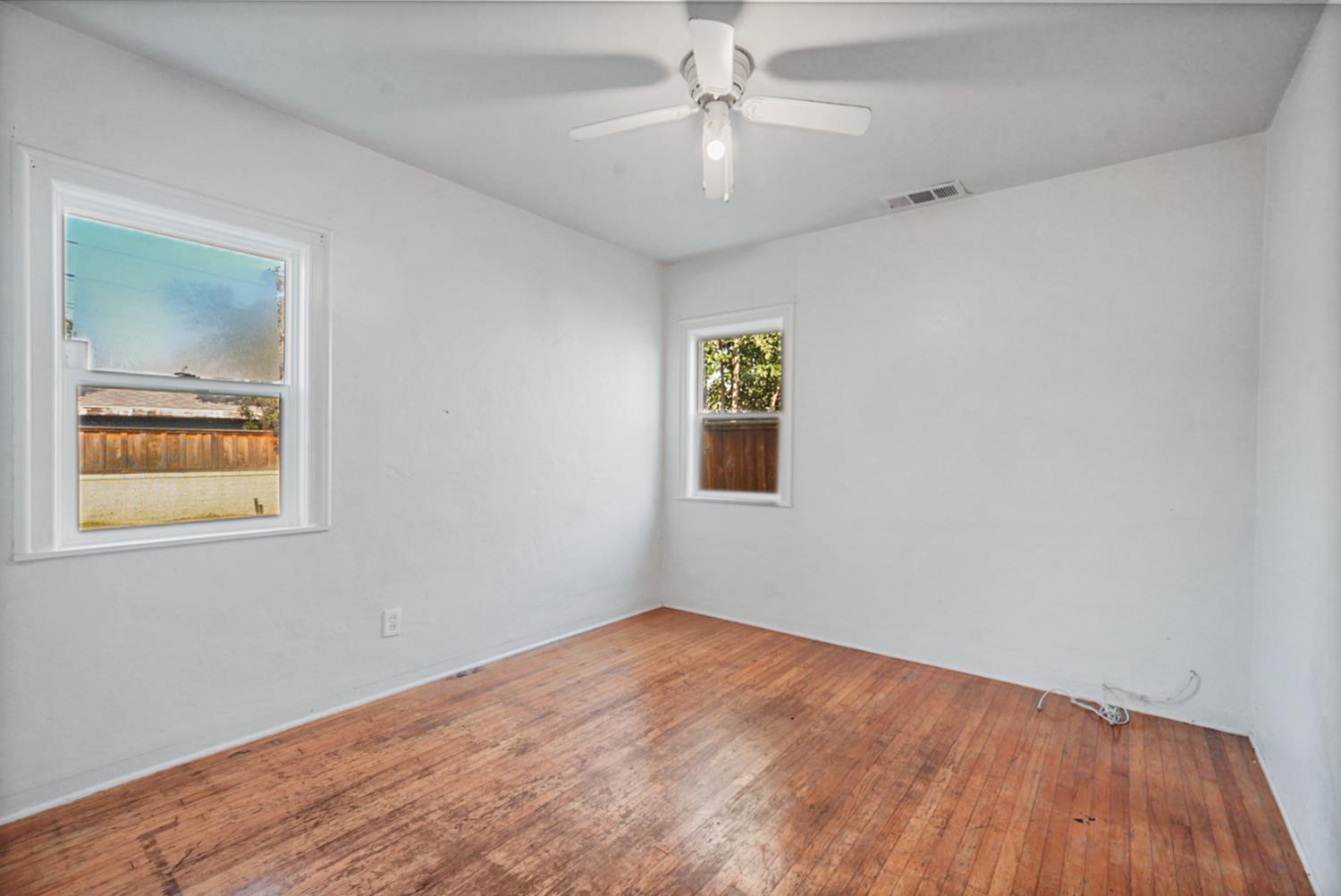 1899 Union Avenue Merced, CA 95340 - Photo 9 of 27 a view of an empty room with a window and wooden floor