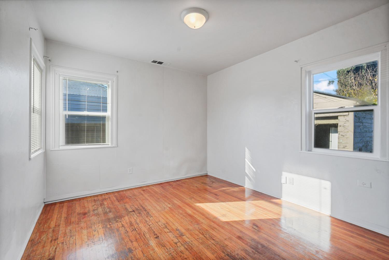 1899 Union Avenue Merced, CA 95340 - Photo 10 of 27 a view of empty room with wooden floor and fan