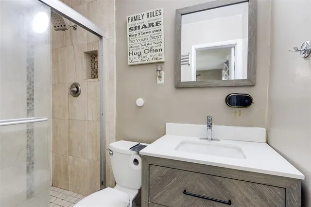 a bathroom with a sink toilet and shower