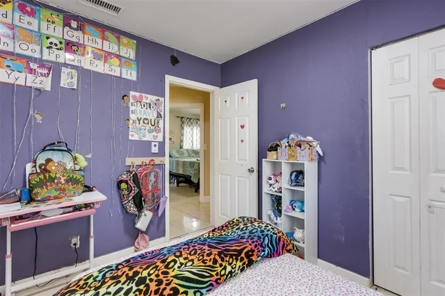 a bedroom with a bed and a dresser