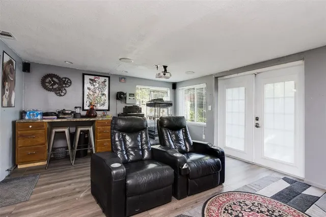 a living room with furniture and wooden floor