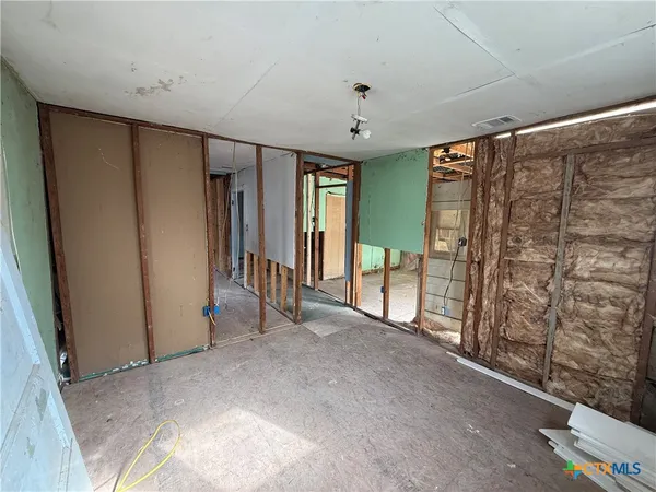 a view of an empty room and a window