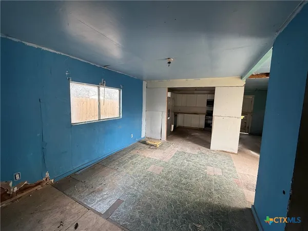 a kitchen with granite countertop a refrigerator and a stove top oven