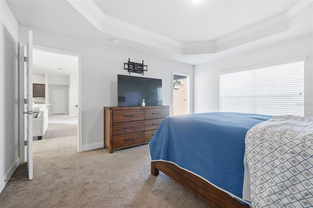 9144 Southeast 47th Court Road Ocala, FL 34480 - Photo 16 of 32 a bedroom with a bed and a flat screen tv