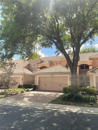 a front view of a house with a yard and a garage
