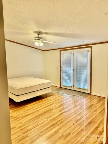 a view of bathroom with a sink mirror and window