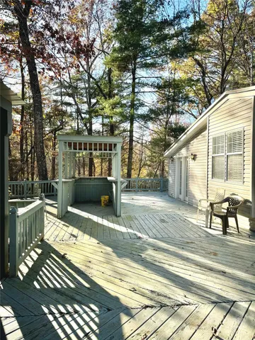 a view of a patio with table and chairs and wooden floor
