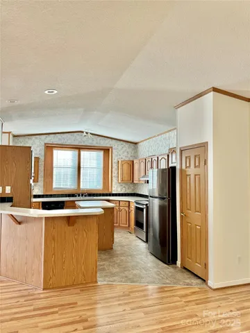 a kitchen with stainless steel appliances granite countertop a stove and refrigerator