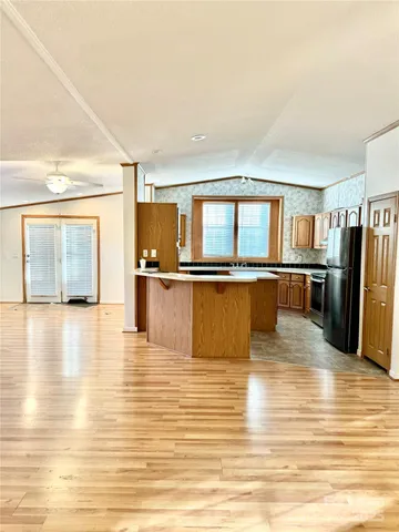 a view of a room with wooden floor and a fireplace