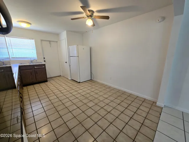 a view of a room with window and a ceiling fan