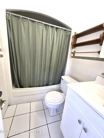 a bathroom with a toilet a sink and a mirror