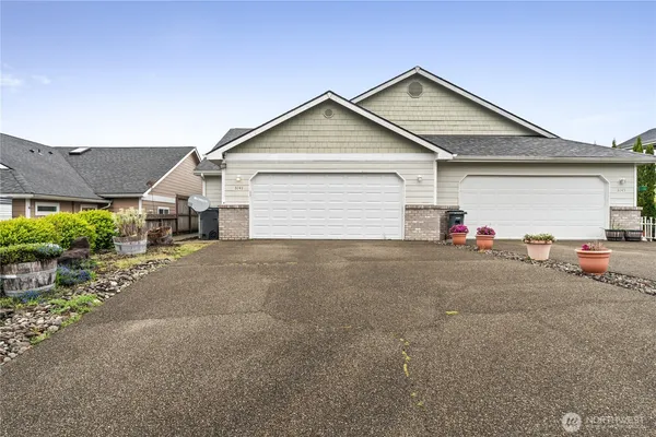 a view of a house with a yard and garage