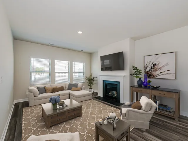 a living room with furniture a fireplace and a flat screen tv