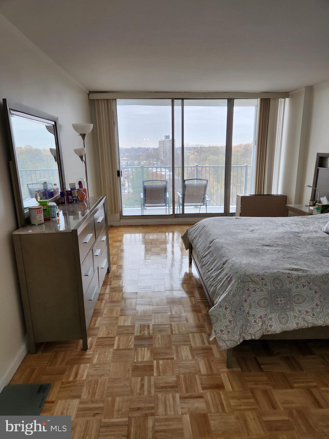 3900 West Ford Road, Unit 12A Philadelphia, PA 19131 - Photo 30 of 46 a spacious bedroom with a large bed and a large window