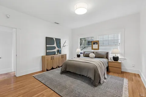 a bedroom with a bed and a night stand