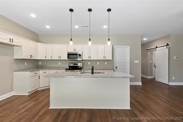 a view of a kitchen with a stove cabinets and a wooden floor
