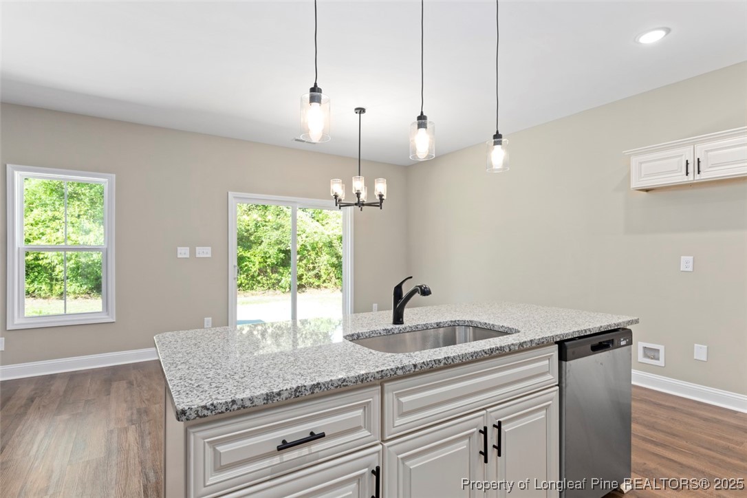 5578 Philippi Church Road Raeford, NC 28376 - Photo 14 of 33 a kitchen with granite countertop kitchen island white cabinets and a chandelier