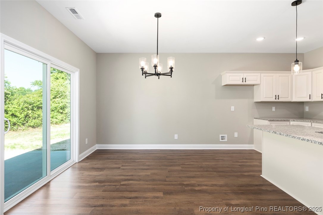5578 Philippi Church Road Raeford, NC 28376 - Photo 16 of 33 a view of a kitchen with a stove cabinets and a wooden floor