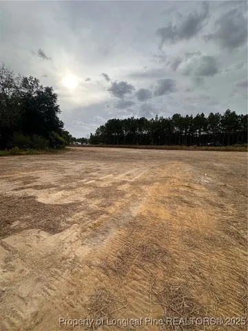 a kitchen with stainless steel appliances kitchen island granite countertop a refrigerator a sink dishwasher and wooden cabinets