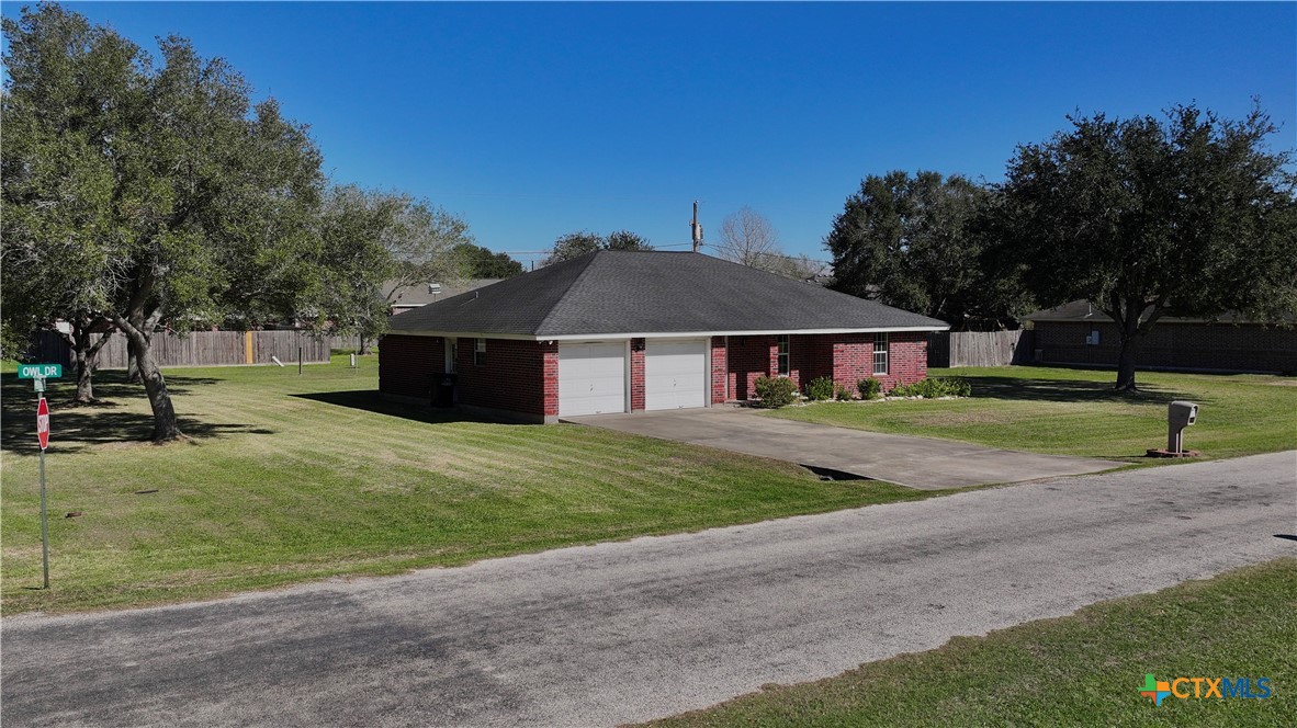 102 Owl Road Victoria, TX 77905 - Photo 16 of 19 a front view of a house with a garden