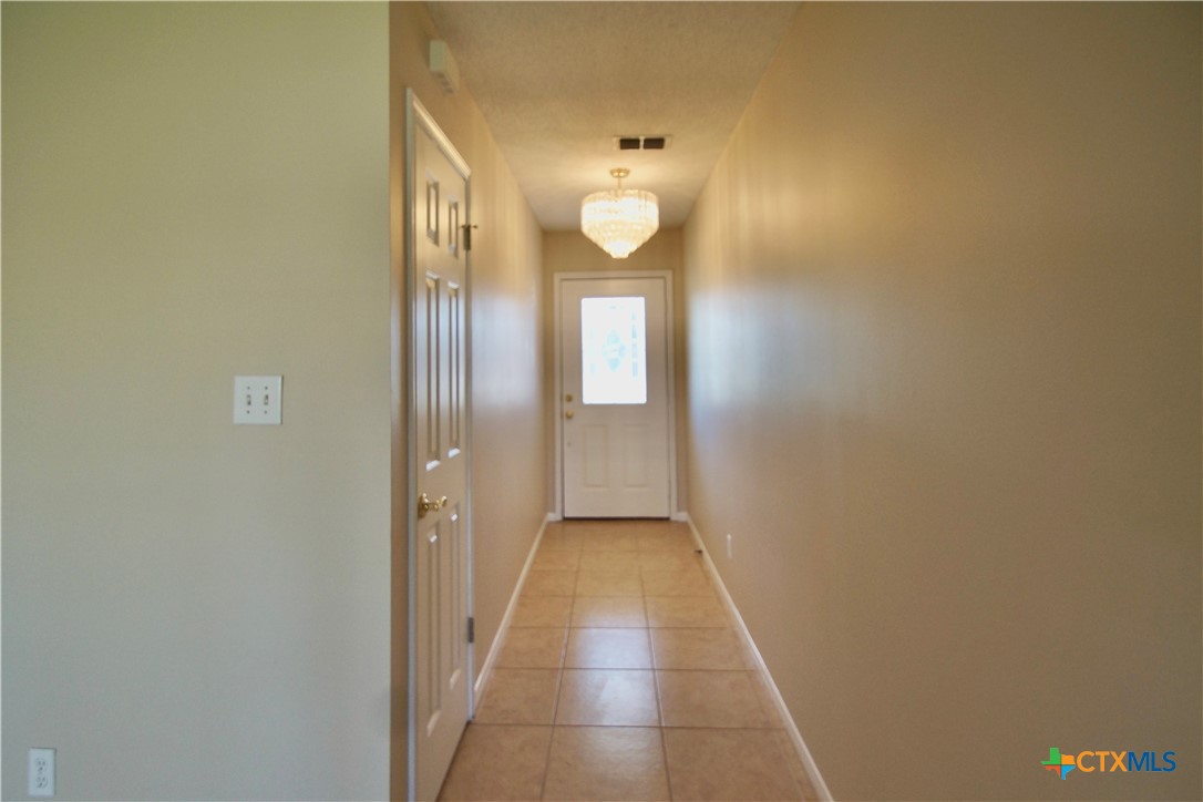 102 Owl Road Victoria, TX 77905 - Photo 2 of 19 a view of a hallway with wooden floor