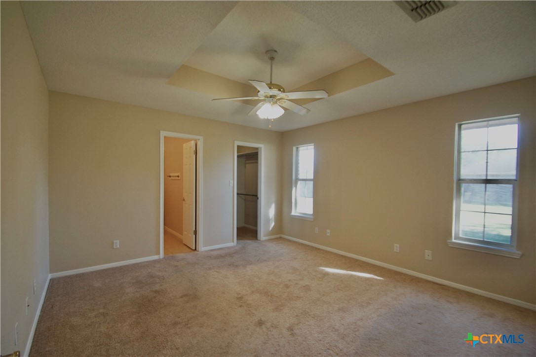102 Owl Road Victoria, TX 77905 - Photo 6 of 19 an empty room with windows and ceiling fan