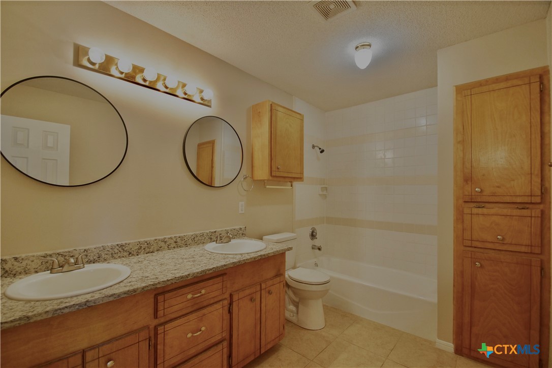 102 Owl Road Victoria, TX 77905 - Photo 8 of 19 a bathroom with a double vanity sink and a mirror