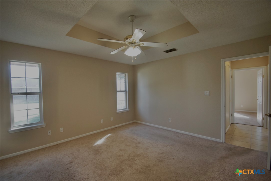 102 Owl Road Victoria, TX 77905 - Photo 10 of 19 an empty room with windows and fan