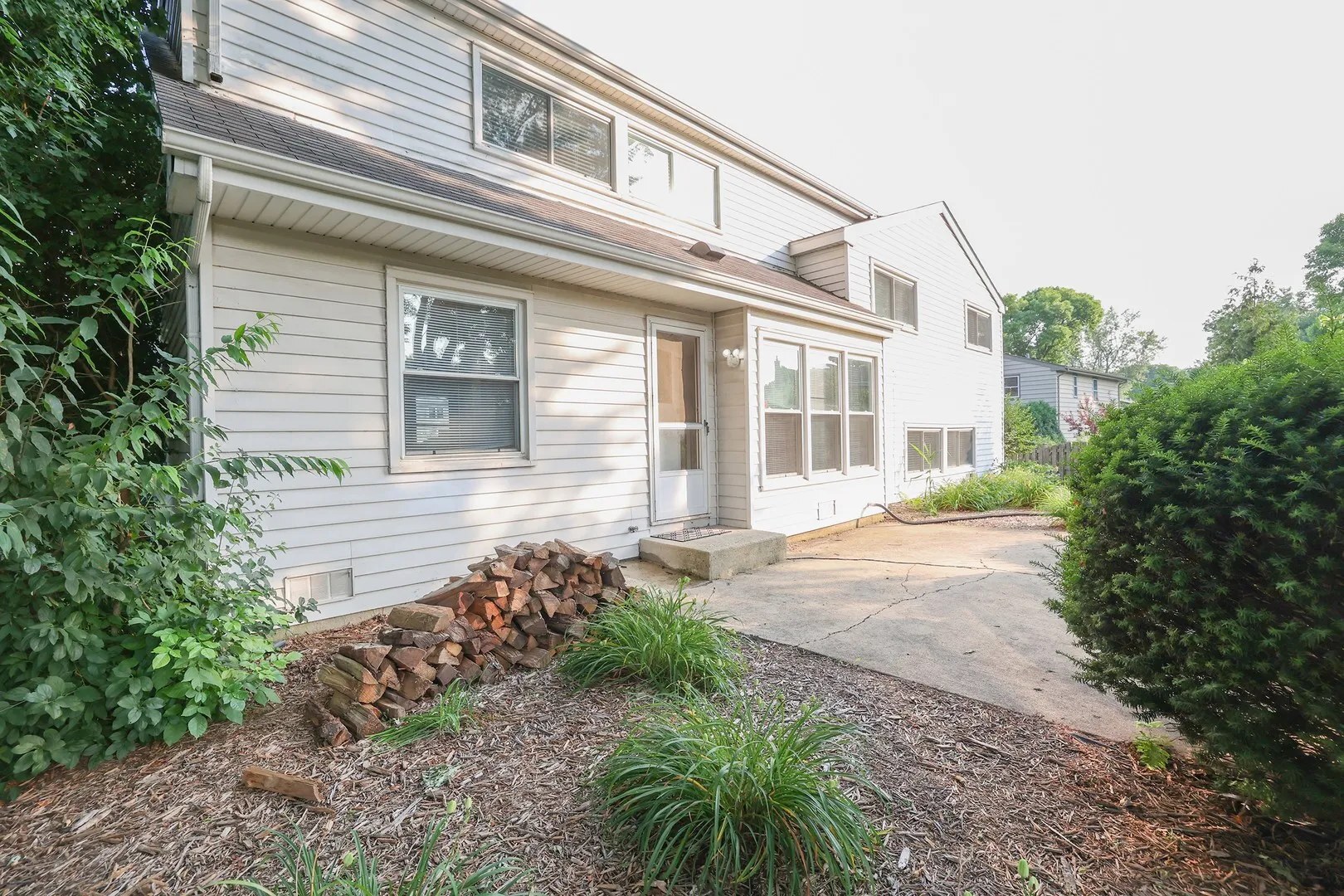 1329 Stonegate Road Naperville, IL 60540 - Photo 2 of 19 a front view of a house with garden