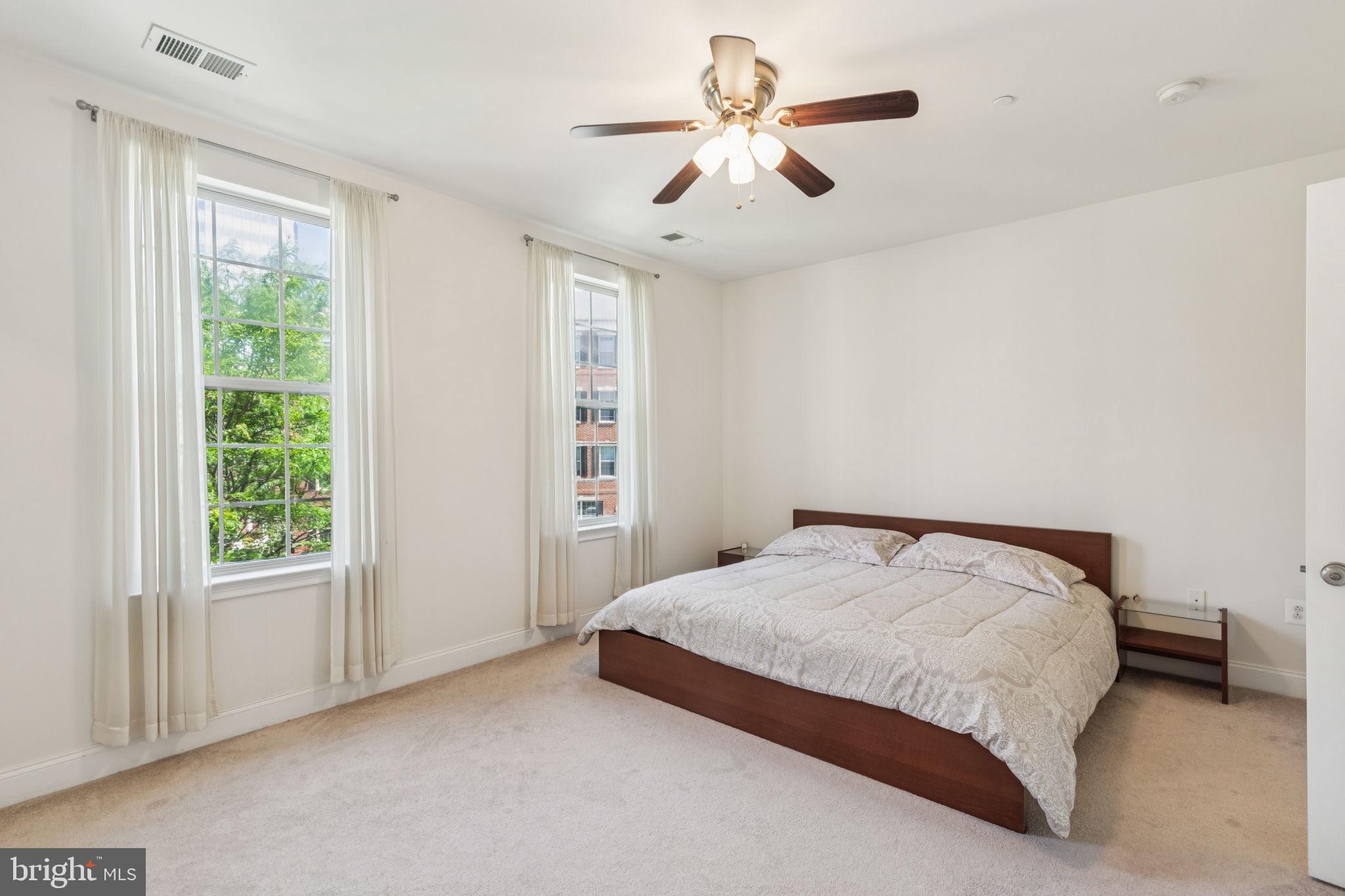 105 Commodore Court Philadelphia, PA 19146 - Photo 12 of 26 a bedroom with a large bed and a chandelier
