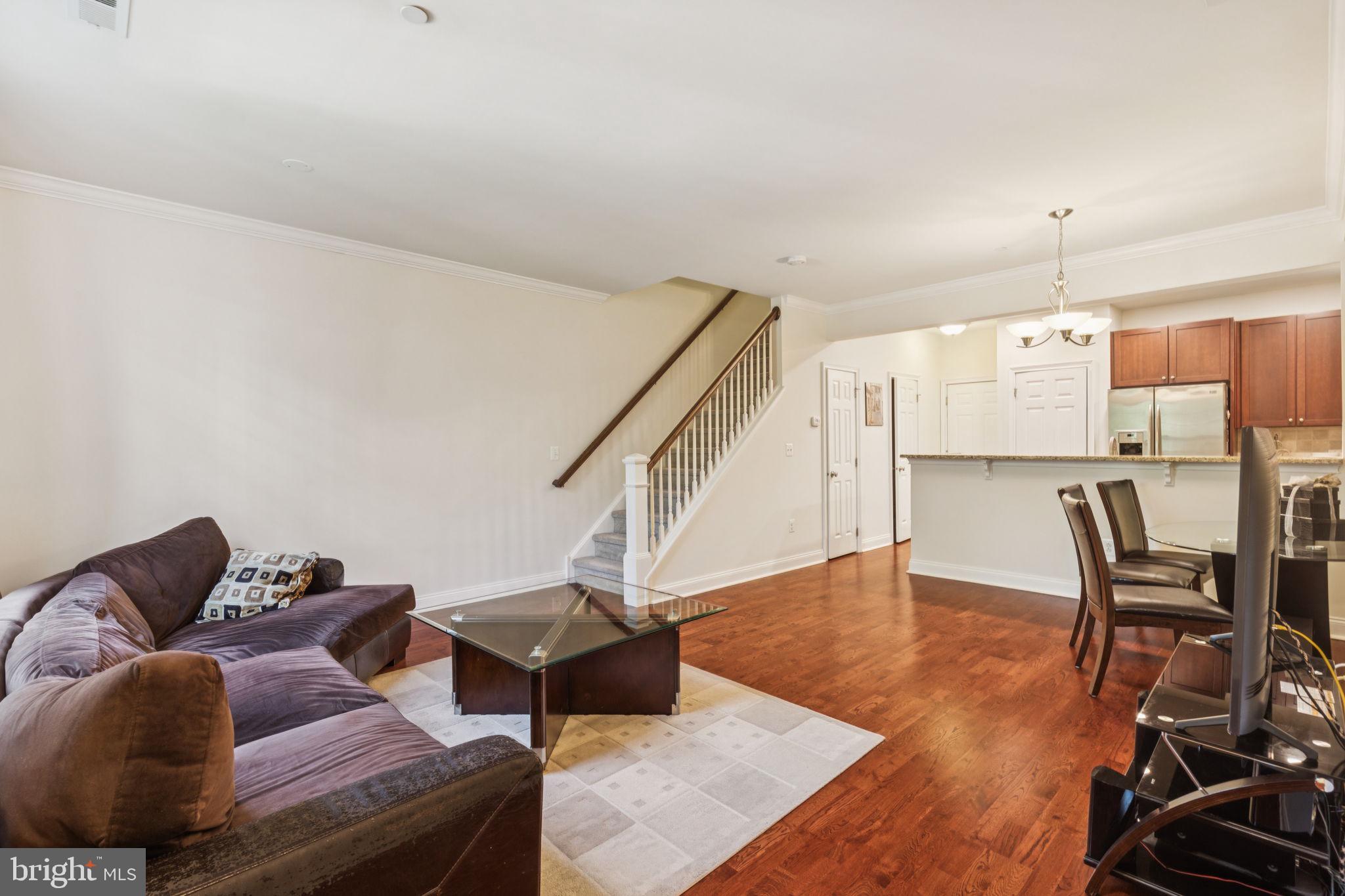 105 Commodore Court Philadelphia, PA 19146 - Photo 2 of 26 a living room with furniture and a dining table with wooden floor