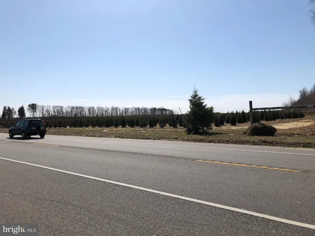 a view of street with a car parked on road