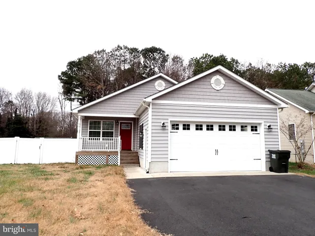 a view of a white house with a yard