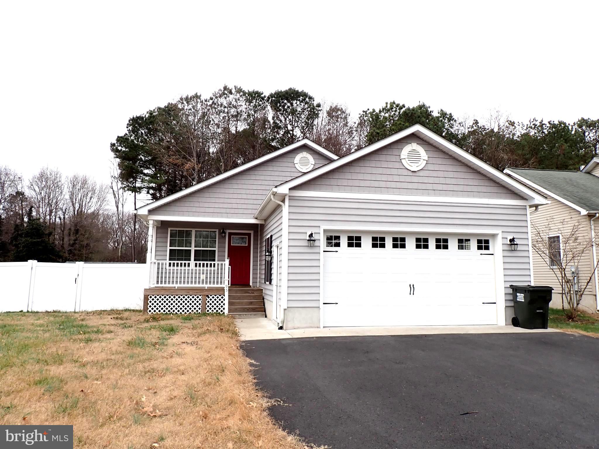 a view of a white house with a yard