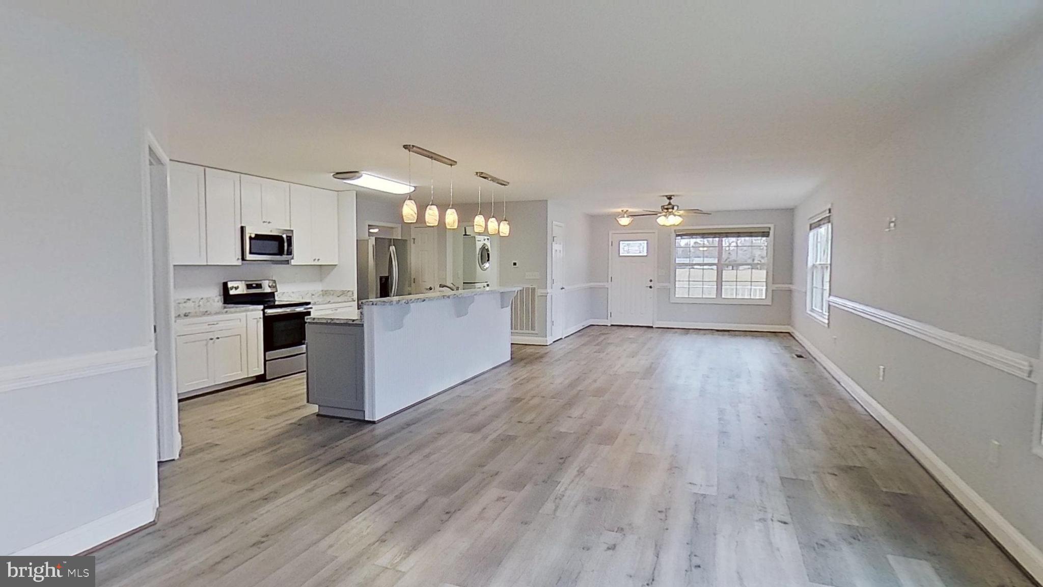 95 Rolando Drive Colonial Beach, VA 22443 - Photo 12 of 39 a view of a kitchen with wooden floor and a window
