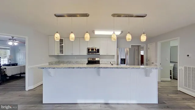 a view of a living room and kitchen