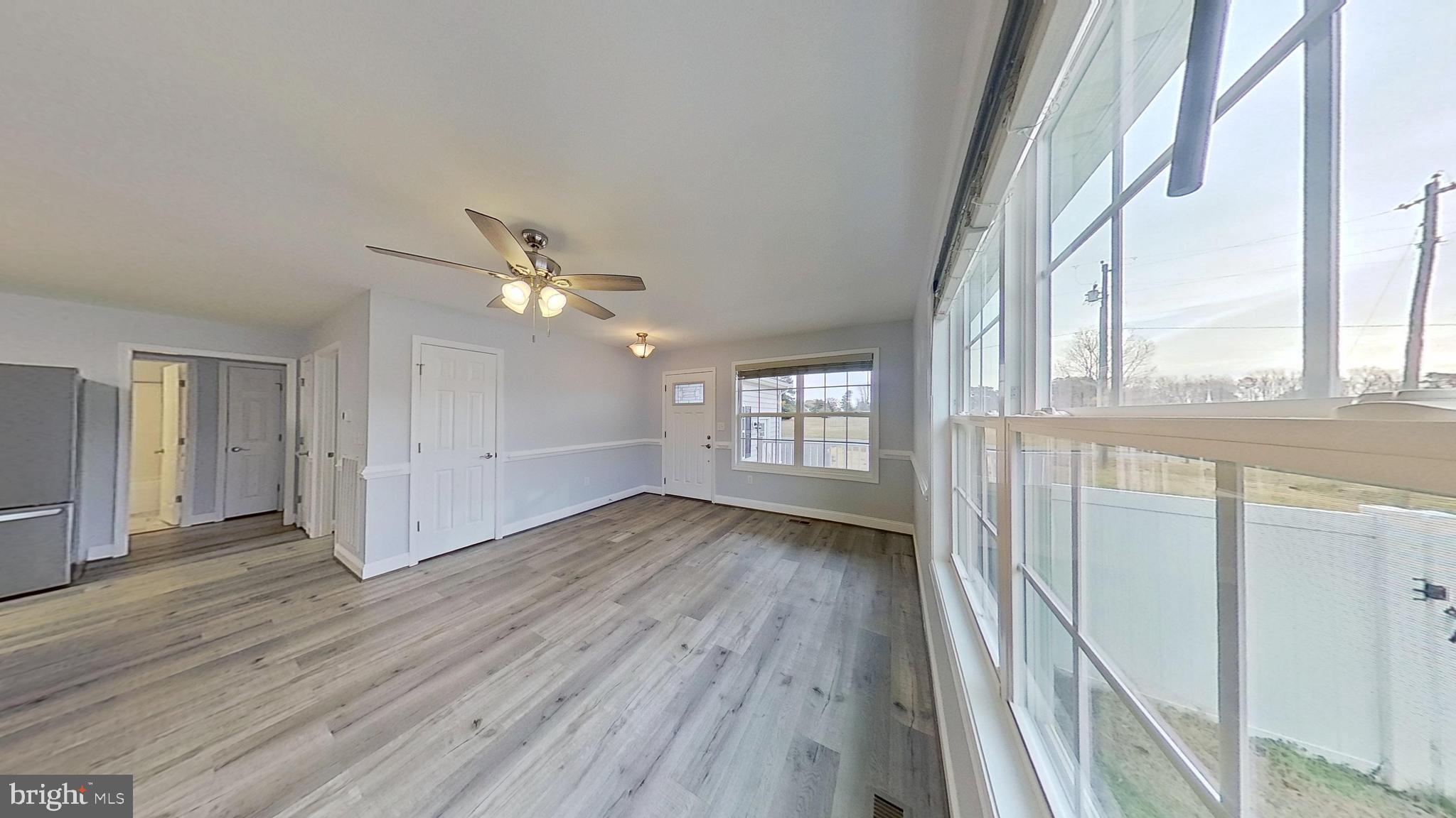 95 Rolando Drive Colonial Beach, VA 22443 - Photo 20 of 39 a view of a livingroom with wooden floor and a ceiling fan